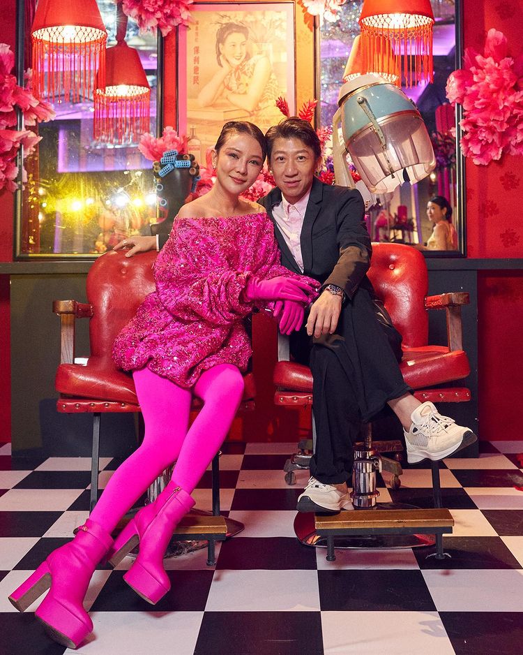 Guests pose with the GuocoLand Hair Salon backdrop at PINCNY2023 event