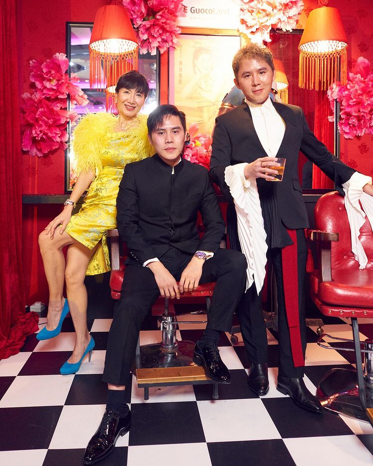 Guests pose with the GuocoLand Hair Salon backdrop at PINCNY2023 event
